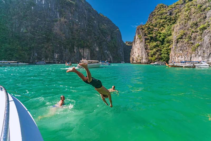 Enjoying a swim in the clear turquoise waters of Phi Phi Island on a relaxing Phi Phi Island Tour