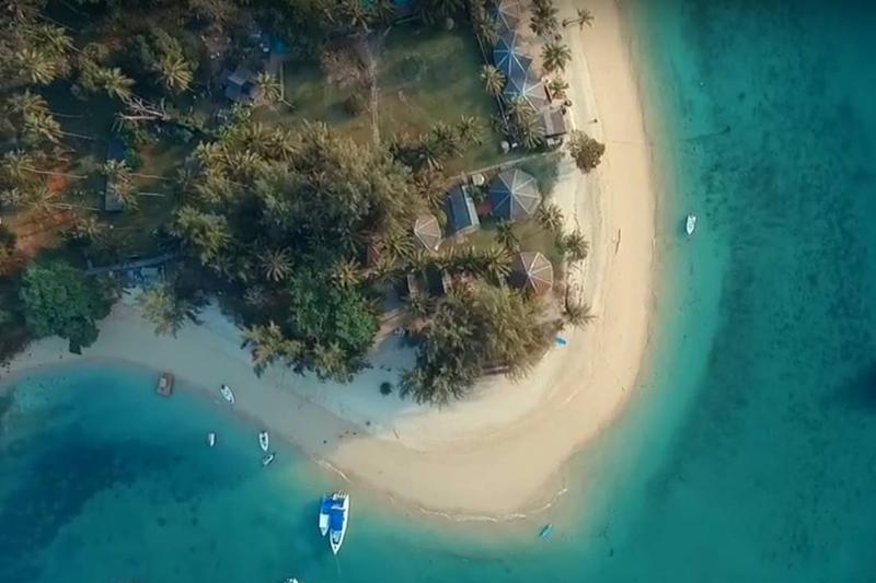 Relax on the serene Koh Naka Noi Beach, with white sands and calm blue waters, ideal for beach lover