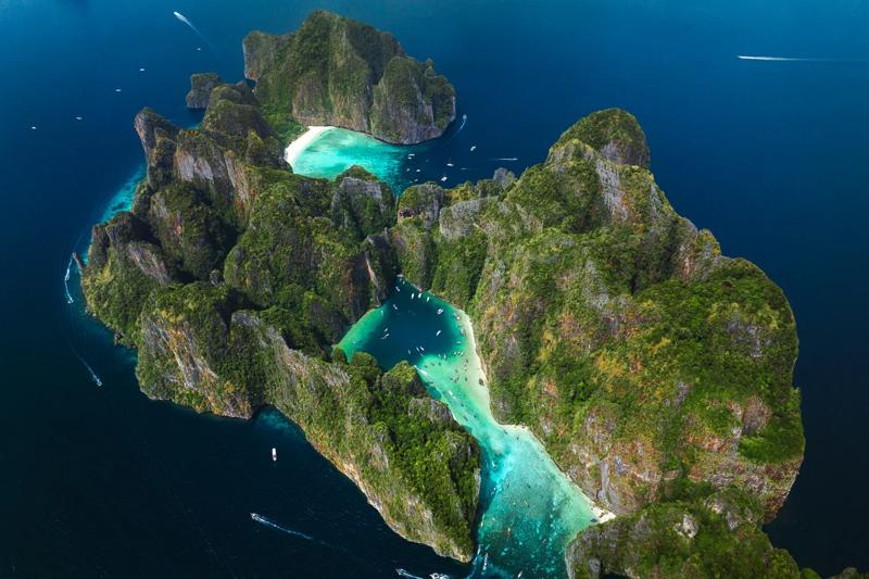 Viking Cave in Phi Phi Islands, Thailand, featuring ancient paintings and high limestone cliffs.