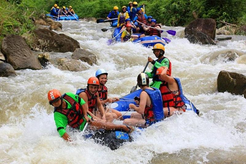 Thrill-seekers enjoying white-water rafting on a turbulent river.
